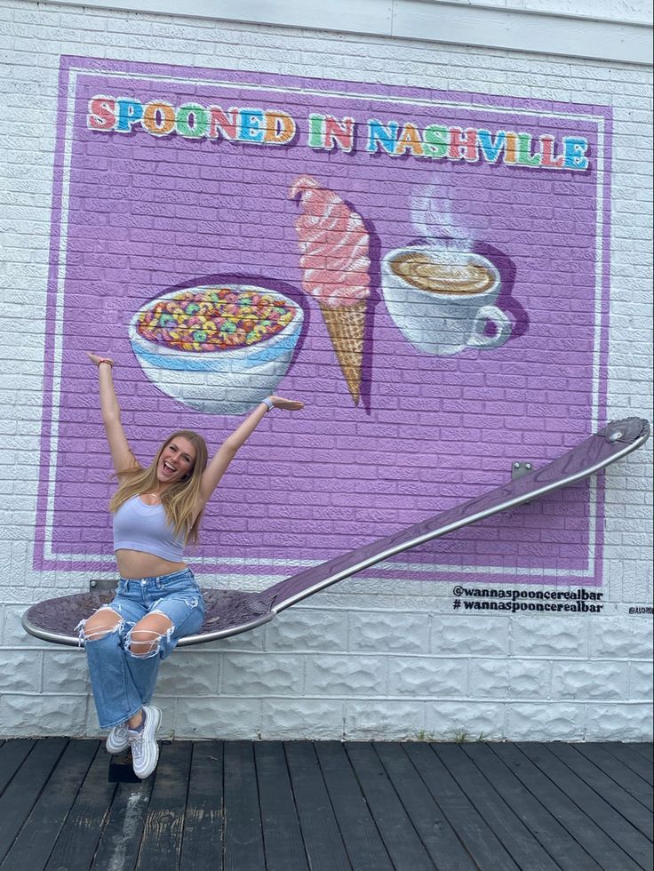 a woman is posing in front of a wall with food and ice cream on it