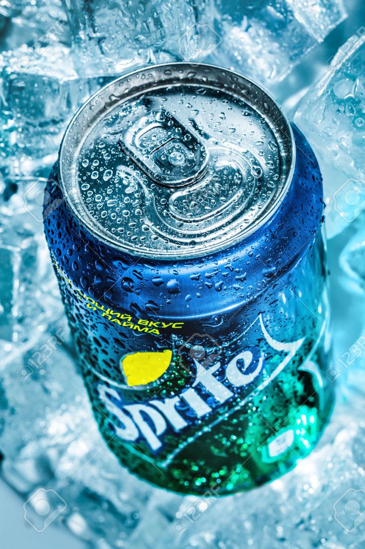 a can of soda sitting on top of ice