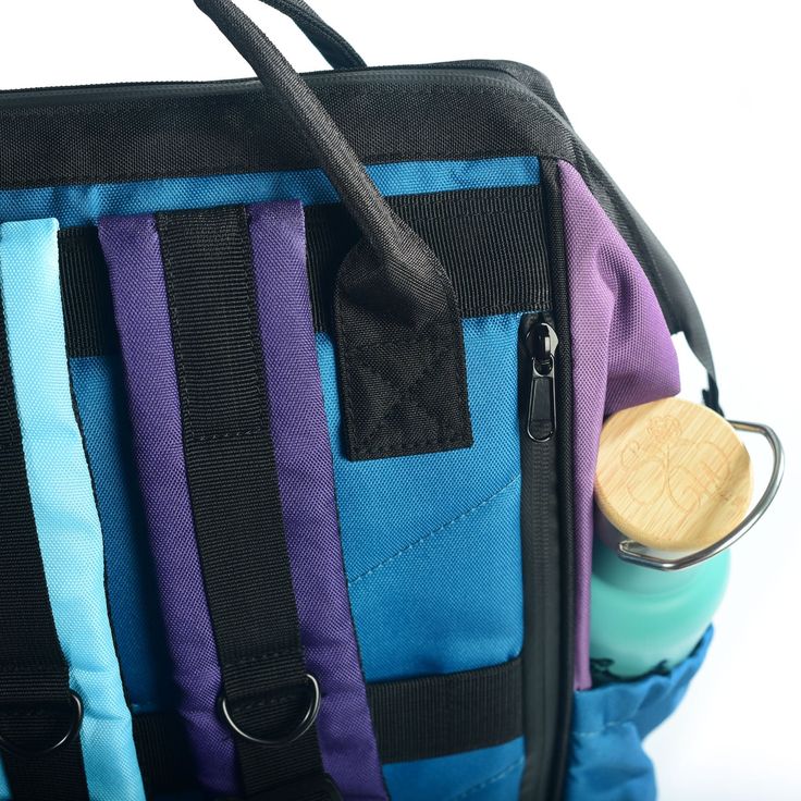 Color Block patchwork in violet, grape and teal shades. Our laptop backpack is everything you need for work, school, travel or adventure! Spacious, tons of organizational pockets and of course our unique and eye catching prints! -Measures approximately 16" tall x 11" wide x 8.5" deep -weighs 1lb 4oz. with a 21.4 liter / 32 lb capacity -Large frame style open main compartment with a roomy padded laptop pocket, zipper pocket, 2 elastic organizational pockets, and 2 pen pockets. -The laptop pocket Functional Purple Standard Backpack, Functional Purple Backpack With Zipper Closure, Travel Backpack With Zipper Pocket, Canvas Material, Purple Backpack With Zipper For On-the-go, Travel Backpack With Removable Pouch, Multicolor, Large Frames, Tablet Sleeve, Quick Release Buckle, Blue Canvas