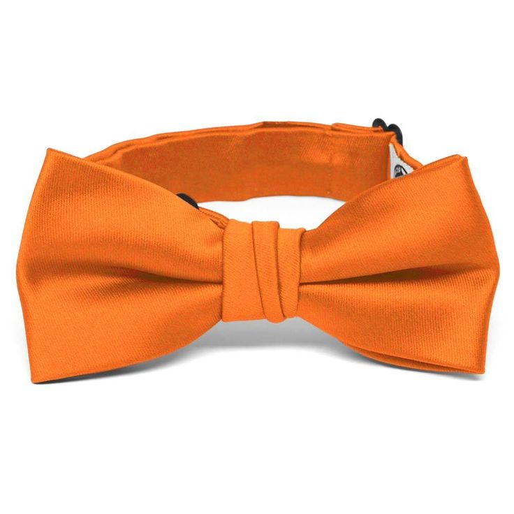 We designed this boys' orange bow tie to match with our popular men's ties. The collar is pre-tied with a band sized for most boys from baby to 10-years old. The heavyweight woven material and smooth satin finish provides a sharp look that is suited for formal occasions. We recommend this shade for a bright orange color. Sizing This bow tie features an adjustable band that expands to fit most babies, toddlers and children up to 10-years old. For older children, pre-teens and teens, we suggest ou Orange Bow Tie, Men's Ties, Orange Bows, Pre Tied Bow Tie, Bow Tie Collar, Color Swatch, Band Collar, Tie And Pocket Square, Color Swatches