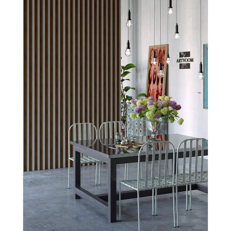 a dining room table with chairs and vases on top of it, in front of vertical blinds