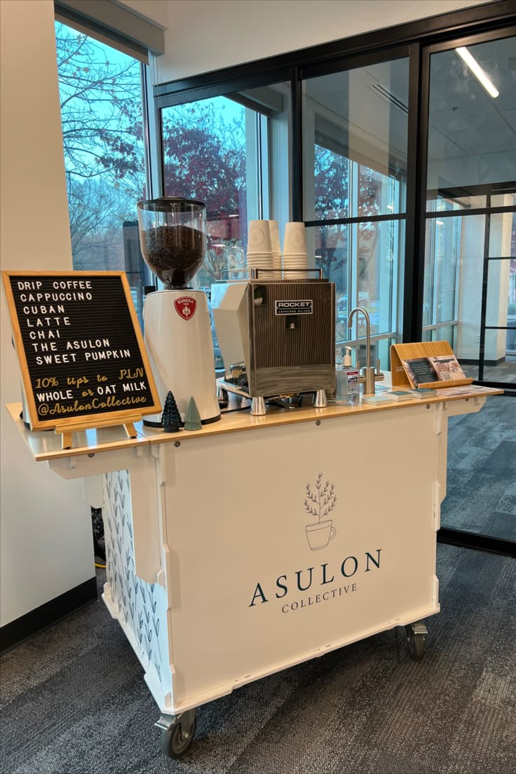 a coffee maker and other items are on display in an office building's reception area