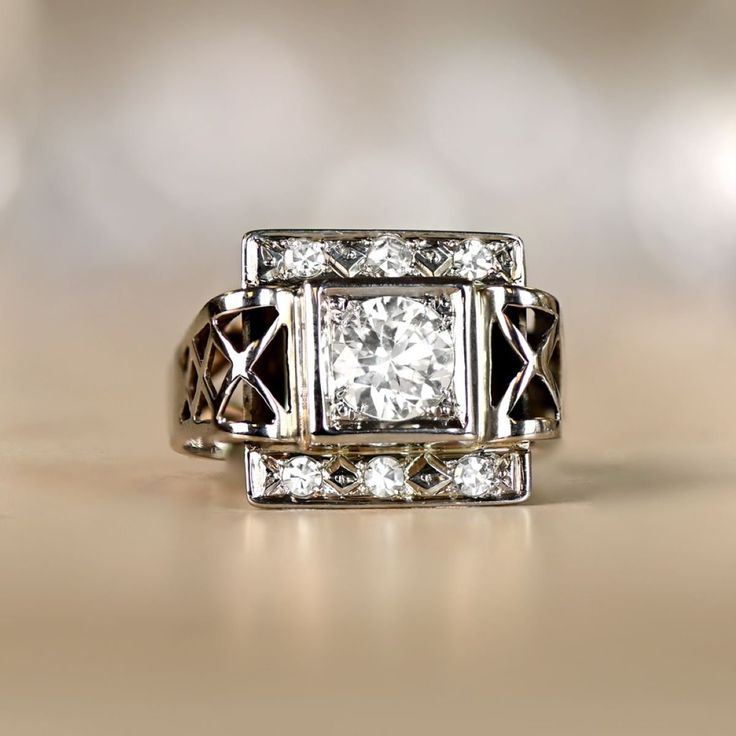 This vintage Retro era ring features a 0.75 carat round brilliant cut diamond, I color and VS1 clarity. Above and below the center stone is a geometric design set with single cut diamonds. The shoulders display lacy open-work. This ring is 18k white gold, and was made in France circa 1945. ✦ DIAMOND SPECIFICATIONS: Diamond Weight: 0.75 Carats Diamond Color: I Color Diamond Clarity: VS1 Color Diamond Cut: Round Brilliant Cut ✦ ENGAGEMENT RING SPECIFICATIONS: Material: 18k White Gold Stones: Diamo Vintage White Gold Signet Ring With Center Stone, Classic Diamond Signet Ring Collectible, Collectible Classic Diamond Signet Ring, Vintage White Gold Signet Ring, Classic Collectible Diamond Ring With Vvs Clarity, Vintage Diamond Signet Ring, Vintage Signet Ring For Anniversary With Round Cut, Vintage Signet Ring With Center Stone For Promise, Classic Collectible Cluster Ring With Diamond Cut