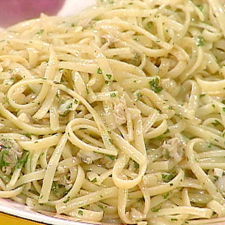 pasta with chicken and parsley in a pink bowl