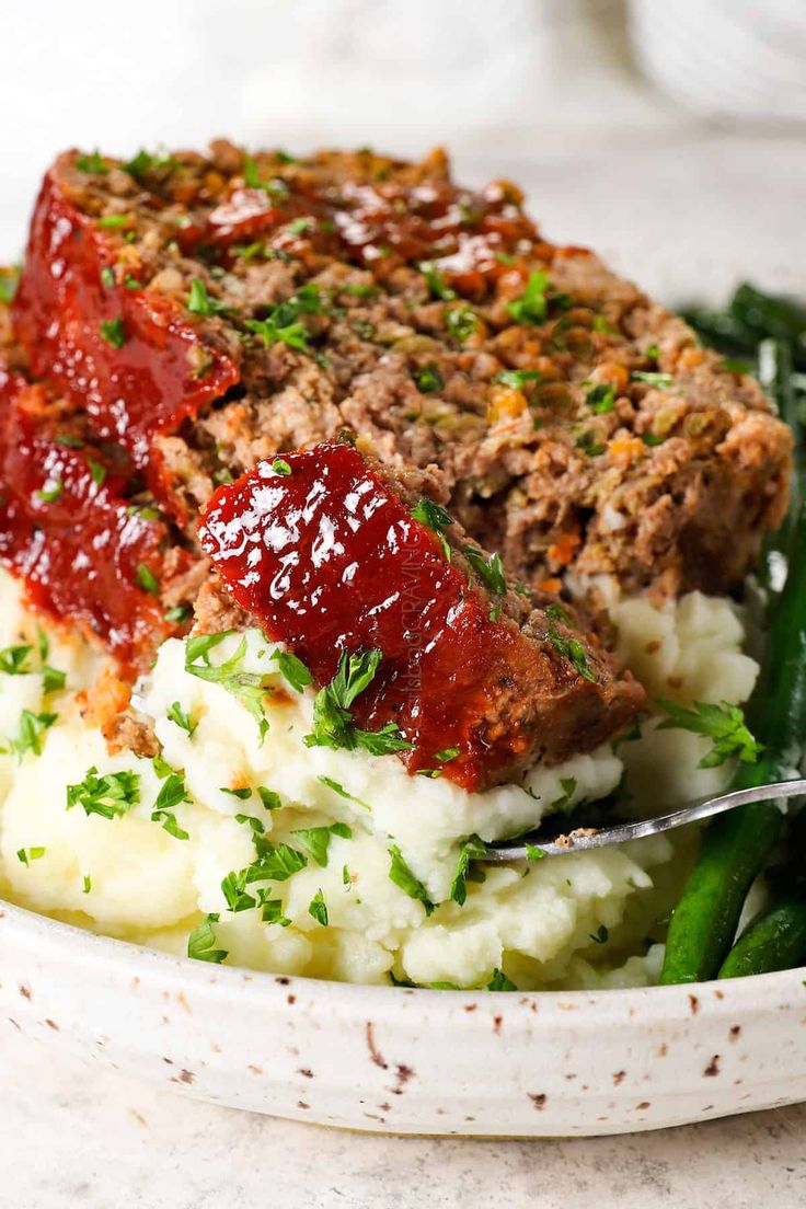 meatloaf with mashed potatoes and green beans in a bowl