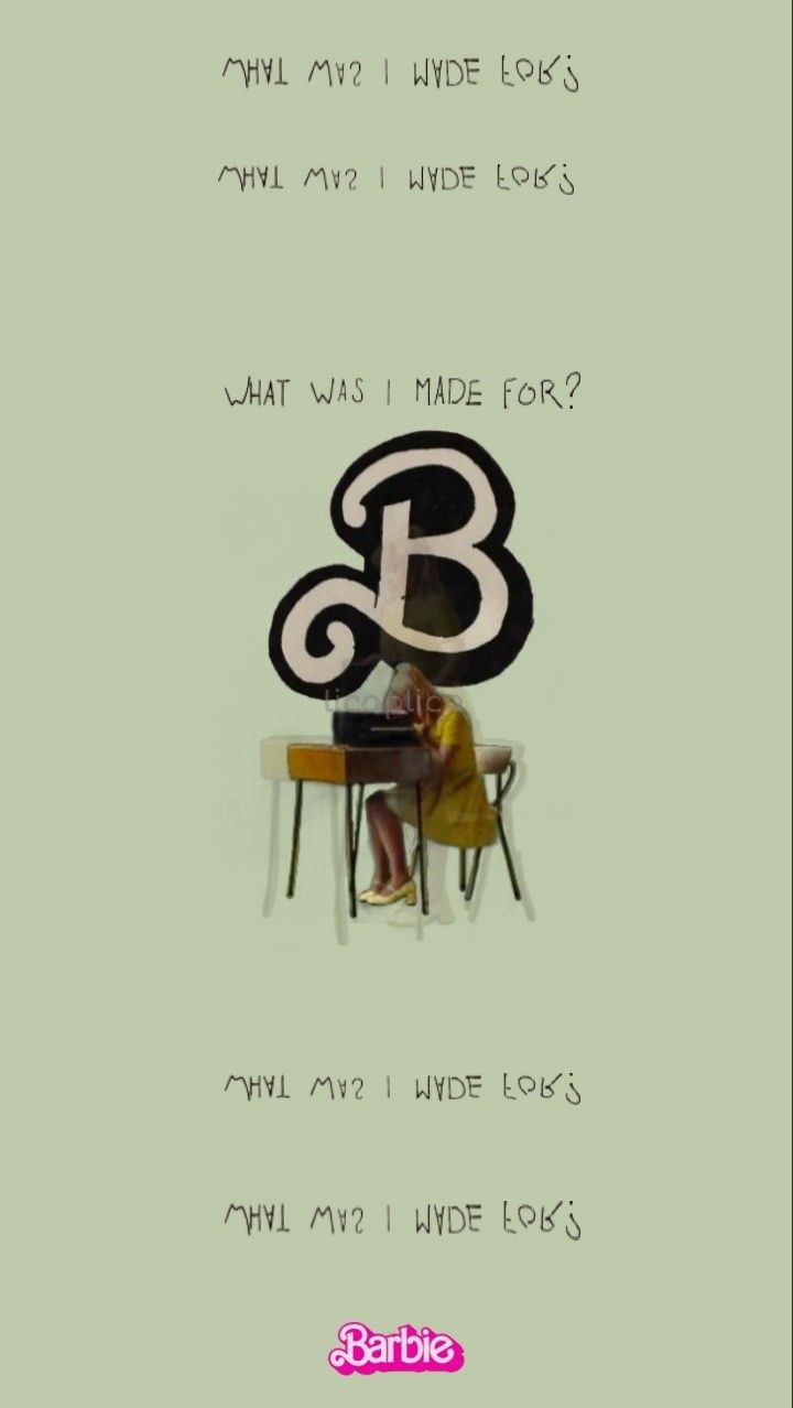 a woman sitting at a desk in front of a letter b