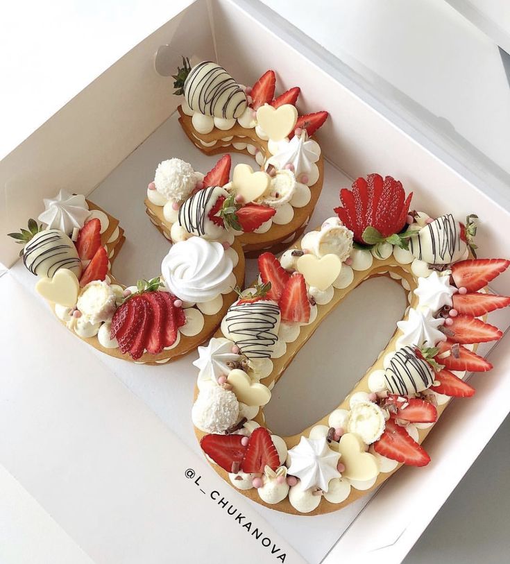 a box filled with cookies and strawberries in the shape of the number 50 on top of each other