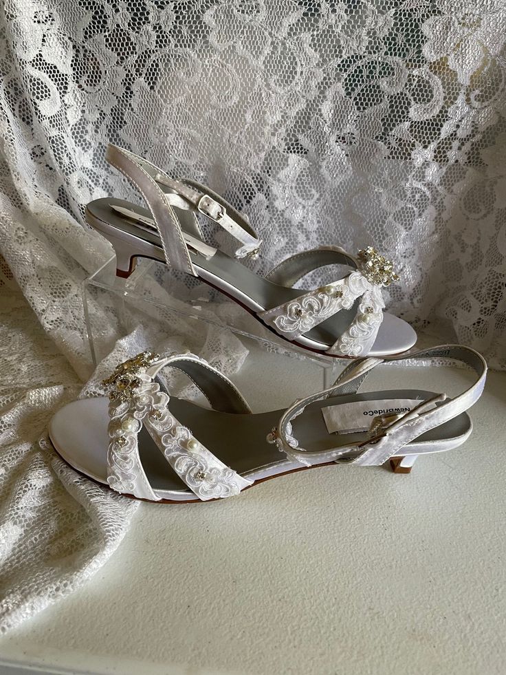 "THIS LISTING IS FOR ONE PAIR SIZE: 9.5 AA Narrow WHITE, STYLE AS SHOWN ON FIRST PICTURE Amazing laze and Crystals Shoes. This shoe is the cutest lowest heel wedding shoes: Heels: 1 1/4'' For super comfort! For Brides who prefer open toes! INSIDE LENGHT: 9 5/8\" INCHES, PLEASE MEASURE YOUR FEET LENGHT TO ENSURE FIT. FINAL SALE, NO RETURNS, NO EXCHANGES. THANK YOU! FOR OTHER SIZES, PLEASE FOLLOW LINK BELOW: www.etsy.com/listing/693079862/white-kitten-heel-shoe-bling-pearls-lace? Colors Available: Wedges Shoes Low, Wedding Shoes Low Heel, White Kitten, Beach Cruise, Kitten Heel Shoes, White Sandals Heels, Satin Shoes, Bling Shoes, Wedding Shoes Heels