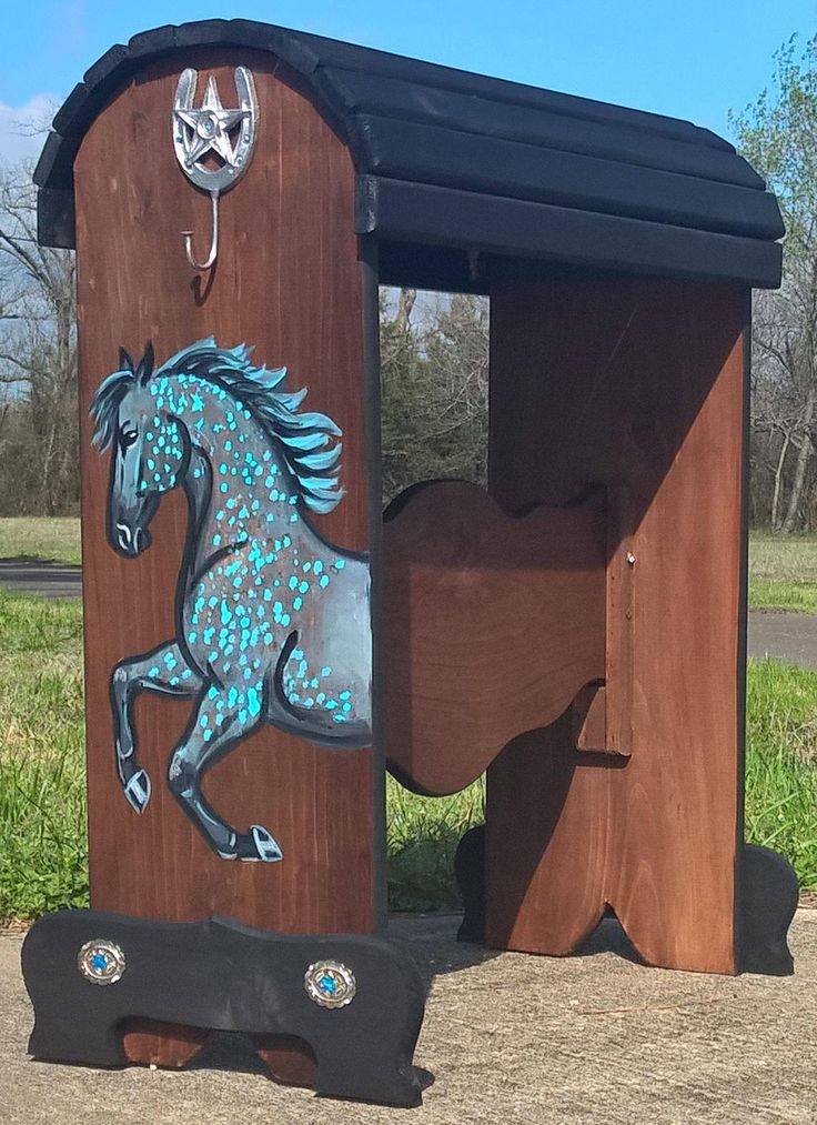 a horse painted on the side of a wooden structure