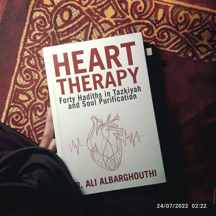 a person holding up a book about heart therapy