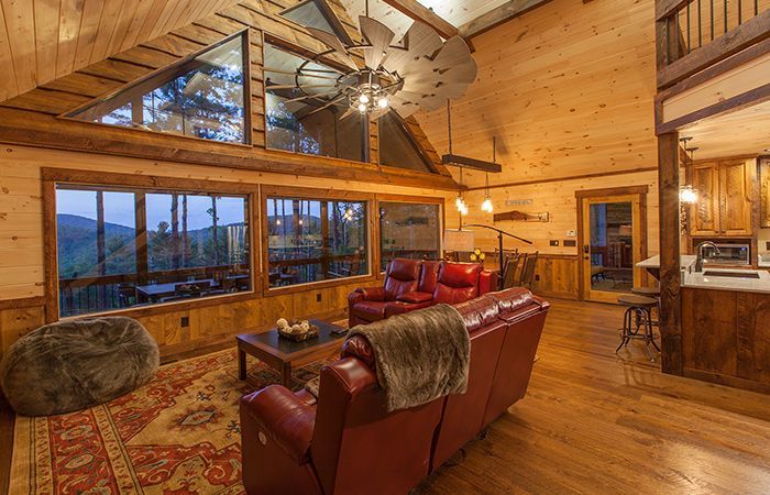 a living room filled with furniture and a ceiling fan