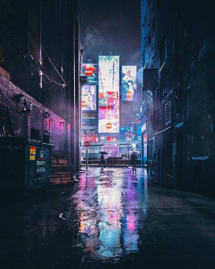 an empty city street at night with neon signs on the buildings and people walking in the rain