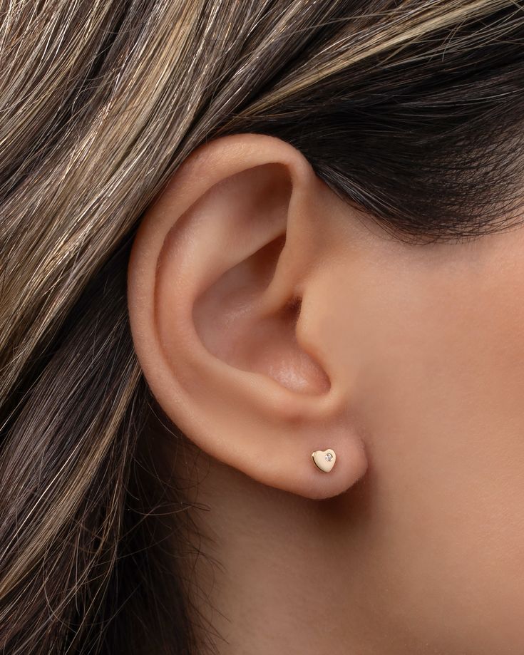 14k gold tiny heart with diamond stud earring. Part of our Tiny Stud collection, this is sold as a single and great for mixing and matching or purchase two for a dainty pair. Available in 14k yellow, white and rose gold. Sold as a Single Size: Approx. 4mm (W) by 4mm (H) Diamond: approx 0.01 ctw Standard Production: 2-7 business days Rush Order Production: 1- 4 business days Shipping: Select shipping method at checkout. Shipped from our L.A. Studio. This item is Final Sale. See here for details. Dainty 14k White Gold Heart Earrings, Tiny Dainty Yellow Gold Heart Earrings, Minimalist White Gold Heart Earrings For Everyday, Dainty Tiny Yellow Gold Heart Earrings, Dainty Rose Gold Heart Earrings, Hypoallergenic 14k Rose Gold Heart Earrings, Diamond Stud Earring, Tiny Studs, Tiny Heart