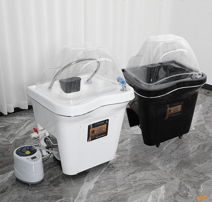 two coolers sitting next to each other on top of a stone floor in front of a white curtain