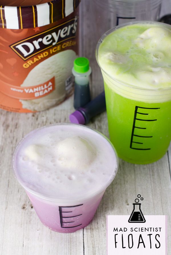 two cups filled with liquid sitting next to each other on top of a wooden table