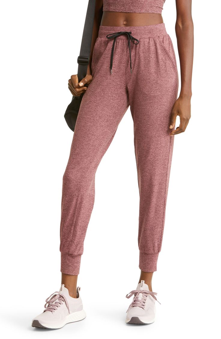 Made from a soft, stretchy recycled blend, these lightweight joggers are the perfect way to kick back in comfort during warmer months. 27" inseam; 9" leg opening; 11" front rise; 14" back rise (size Medium) 88% recycled polyester, 12% spandex Machine wash, tumble dry Imported This product meets Nordstrom Sustainably Sourced Materials criteria: contains at least 30% sustainably sourced materials Lightweight Joggers, Active Wear Pants, Curator Style, Leg Warmers, Parachute Pants, Pajama Pants, Active Wear, Sweatpants, Pants For Women