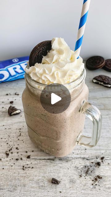 an oreo cookie milkshake in a mason jar