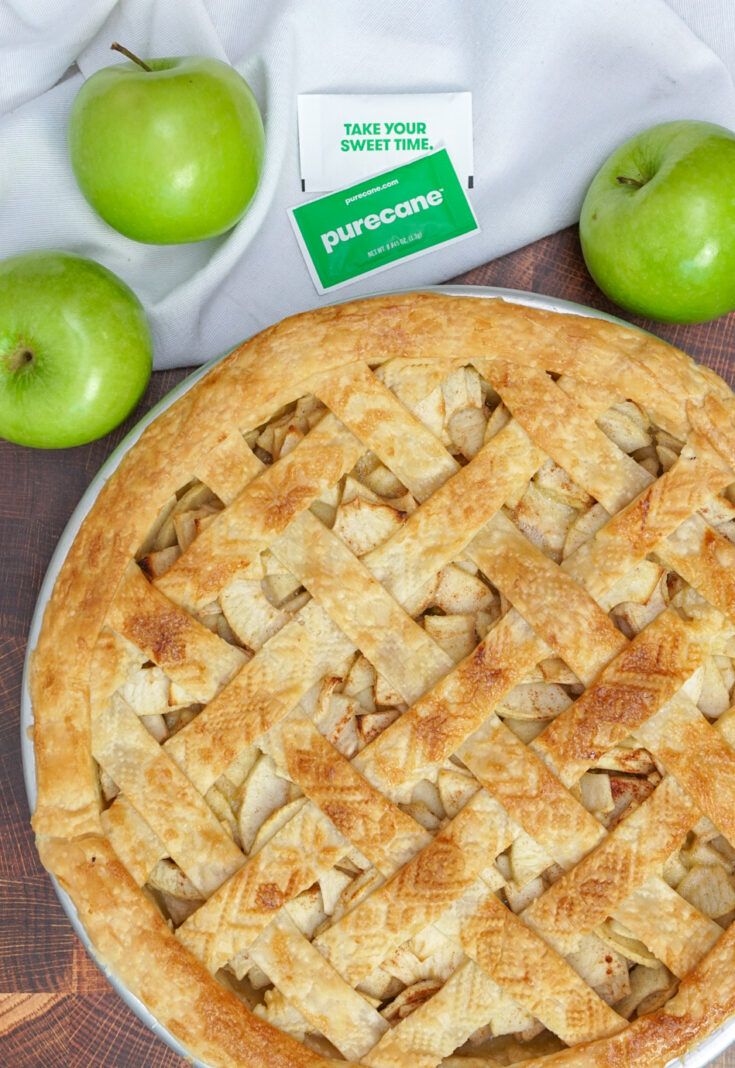 an apple pie sitting on top of a wooden table