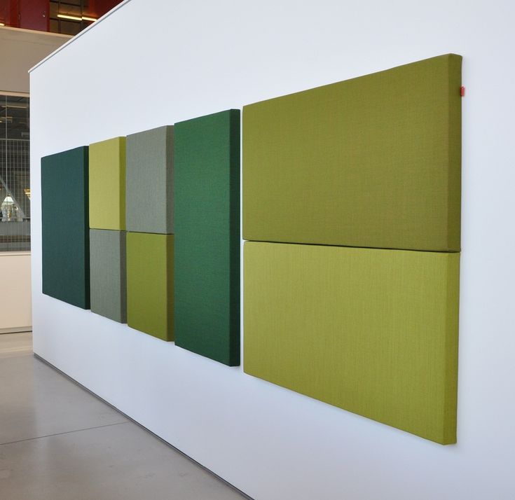 three panels are hanging on the wall in an art gallery, each with different colors