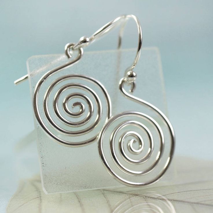 "Simple and timeless. A sterling silver hand forged spiral with large jump ring ready to hang on your favourite chain. The spiral symbol can represent the path leading from outer consciousness (materialism, external awareness, ego, outward perception) to the inner soul (enlightenment, unseen essence, nirvana, cosmic awareness). The symbol has been a favourite of many ancient tribes and people. The thickness of the wire is 1.5 mm and the diameter horizontally is about 20 mm. The length including Modern Spiral Sterling Silver Jewelry, Modern Sterling Silver Spiral Jewelry, Minimalist Spiral Hand Forged Jewelry, Symbolic Spiral Sterling Silver Jewelry, Spiral Hand Forged Sterling Silver Jewelry, Spiral Shaped Sterling Silver Jewelry, Sterling Silver Swirl Jewelry, Sterling Silver Swirl Jewelry In Silver, Hypoallergenic Spiral Sterling Silver Jewelry