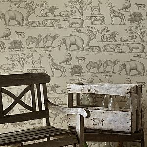 a wooden bench sitting next to a wall with animals on it