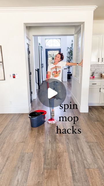 a woman standing on top of a hard wood floor