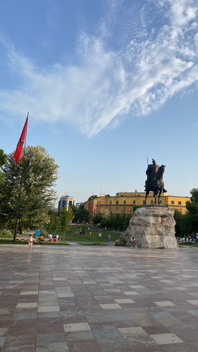 there is a statue of a man riding a horse in the middle of a plaza