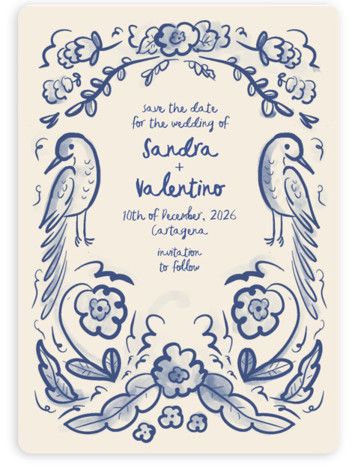 a blue and white wedding card with two birds on the front, surrounded by flowers