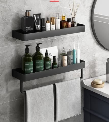 two black shelves with soaps, lotions and other items on them in a bathroom