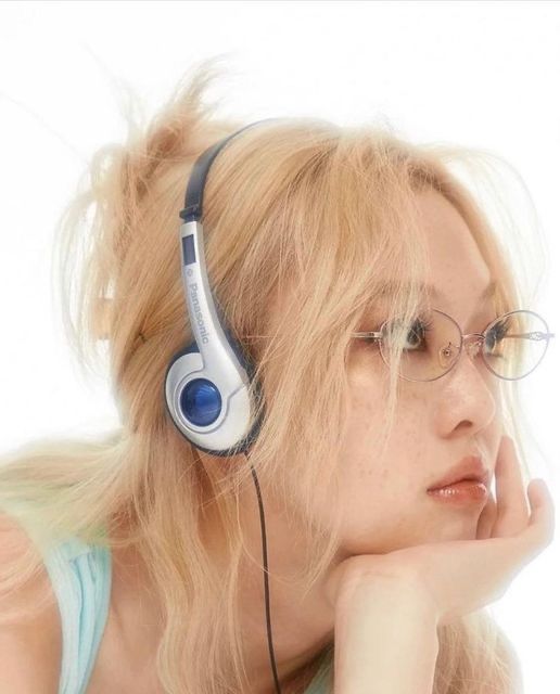 a blonde woman with glasses and headphones on