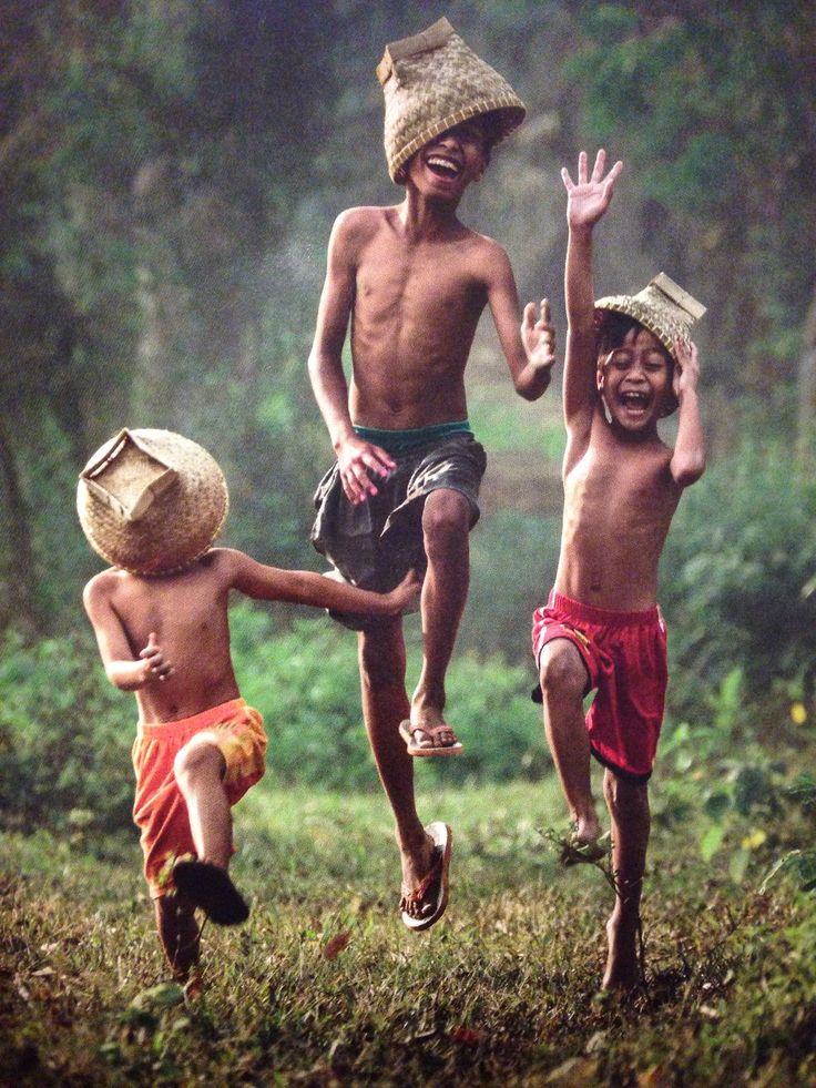 three children running in the grass with a bible verse