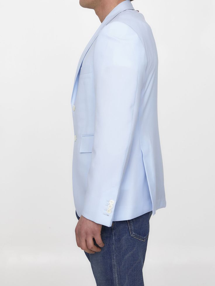 Single-breasted jacket in light-blue wool. It features peaked lapels, front two-button closure, two front flap pockets, a welt pocket on chest and buttoned cuffs. Tricolor grosgrain loop tab at the back of the neck. The model is 190cm tall and wears size 03.Size nationality: US Product number: 699583 Product code: MJC001HF0190480 Composition: 100% WOOL Tailored Blue Blazer With Single Button, Tailored Single Button Blue Blazer, Blue Single Breasted Blazer With Suit Collar, Blue Office Blazer With Pressed Crease, Light Blue Long Sleeve Blazer For Formal Occasions, Formal Light Blue Long Sleeve Blazer, Blue Double-breasted Blazer With Welt Pockets, Light Blue Notch Lapel Blazer For Office, Light Blue Semi-formal Blazer With Suit Collar