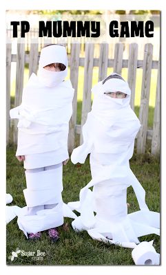 two children dressed up in paper standing next to each other