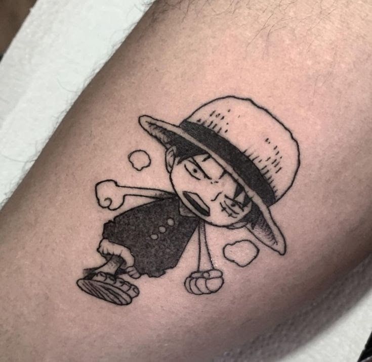 a cartoon character with a hat on his head is depicted in this tattoo style photo