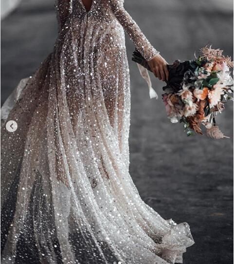 a woman in a long dress holding a bouquet