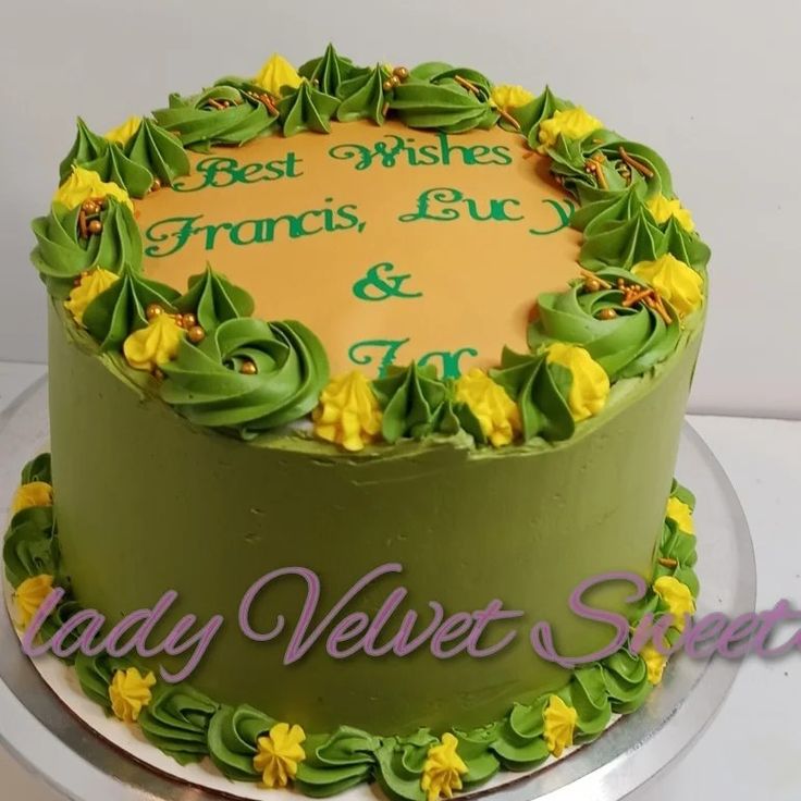 a cake with green frosting and yellow flowers on the top that says best wishes, franois, franois, auc & co