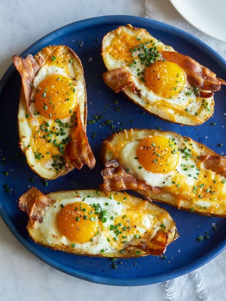 three eggs are in the middle of two pieces of bread on a blue plate