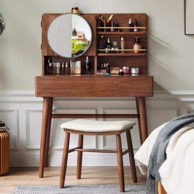 a bedroom with a vanity and stool in it