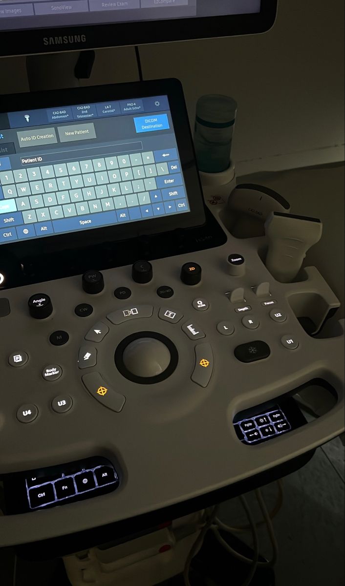 an electronic device sitting on top of a desk next to a computer monitor and keyboard