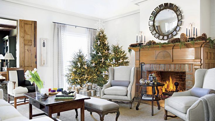 a living room filled with furniture and a christmas tree on top of a mantel