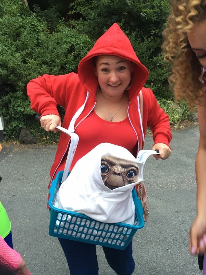 a woman in a red hoodie holding a basket with an image of a baby grooter on it