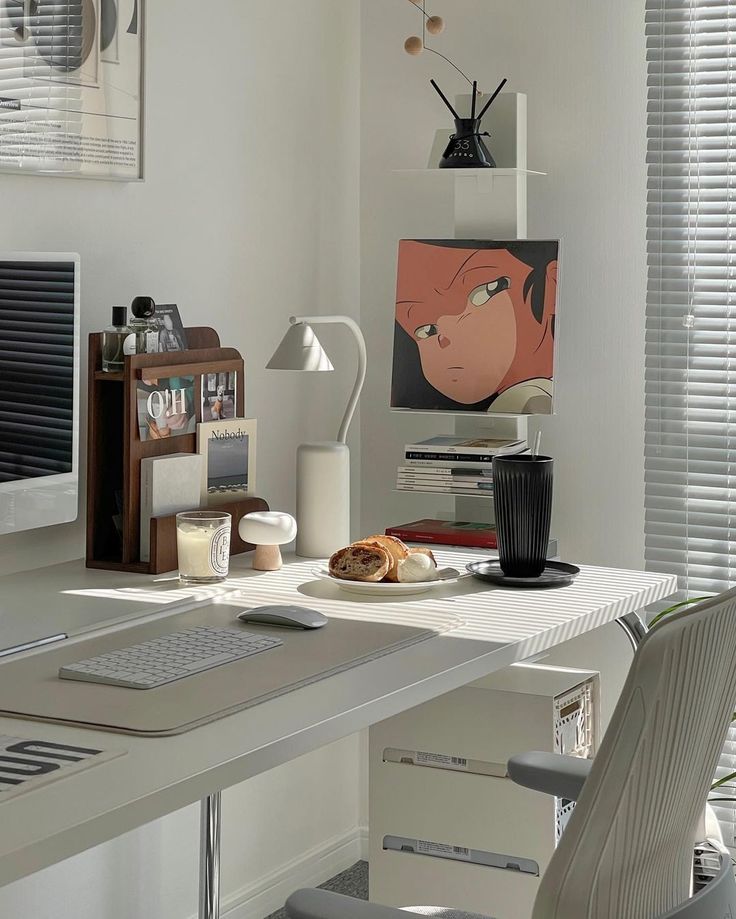 a white desk topped with a computer monitor and keyboard