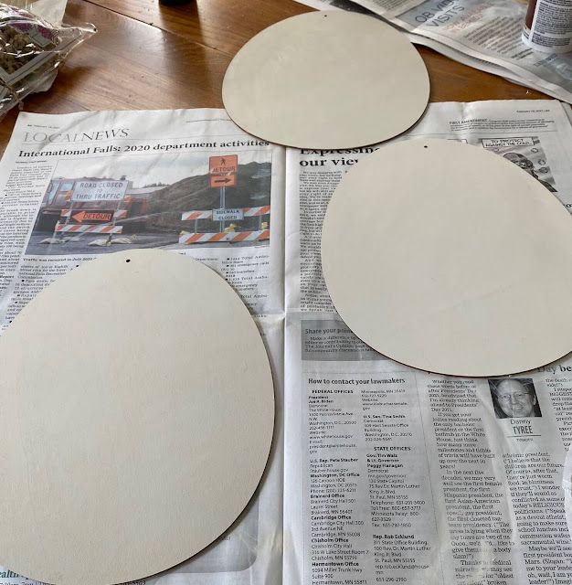 three round white plates sitting on top of a newspaper