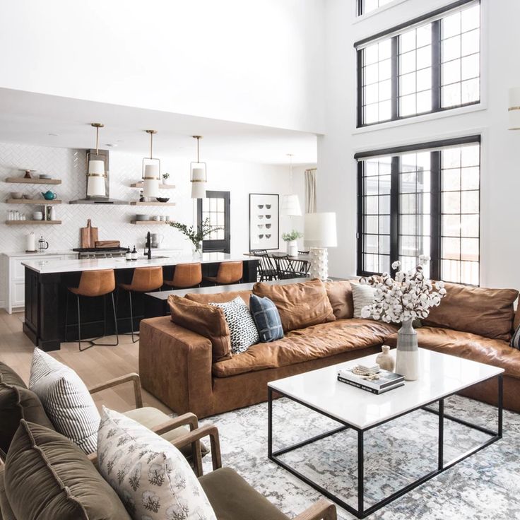 a living room filled with furniture and lots of windows