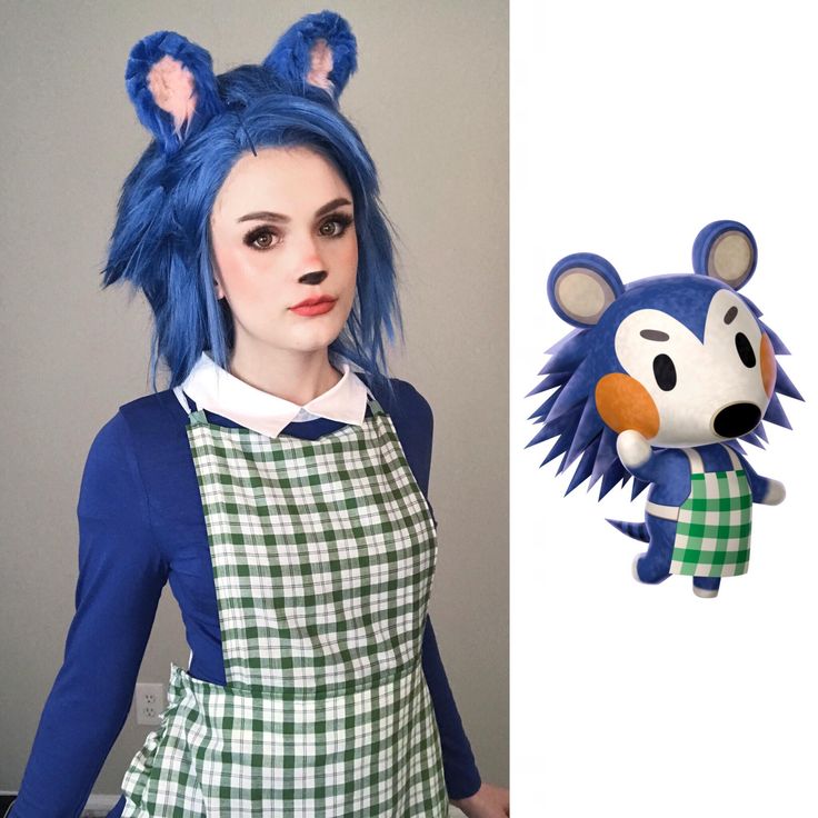 a woman with blue hair wearing an apron and holding a stuffed animal in front of her face