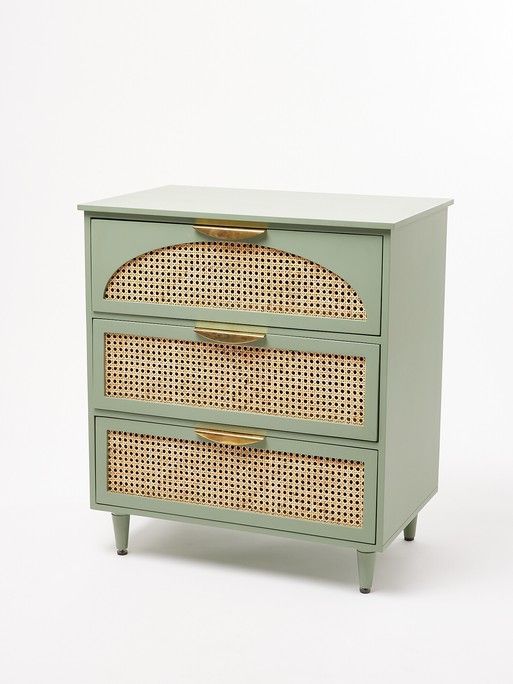 a green dresser with two drawers and wicker design on the top, against a white background