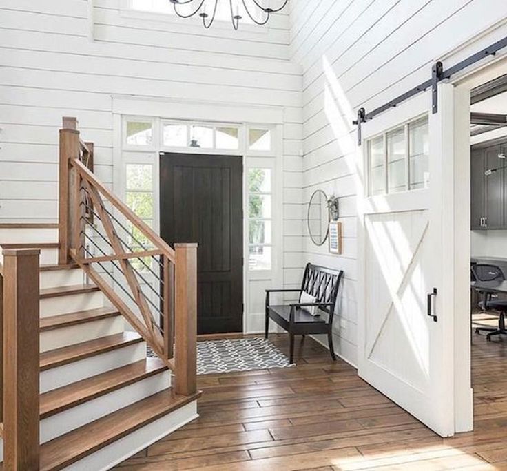 an open living room with stairs leading up to the kitchen