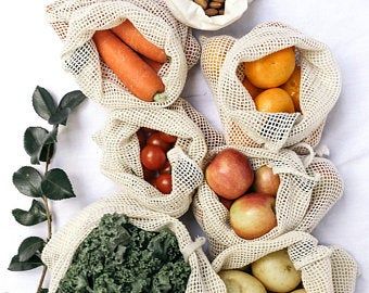 several bags filled with different types of fruits and vegetables