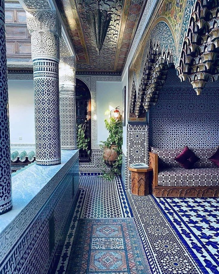 an elaborately decorated room with blue and white tiles on the walls, floors and ceiling