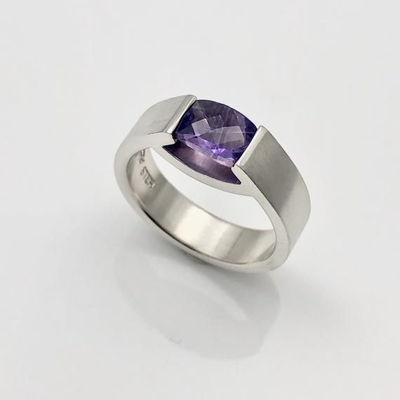 Genuine  purple amethyst checkerboard cut gemstone tension-set into a modern sterling silver ring,  measures 6mm wide and 2 mm thick.custom made in your desired size and gemstone of your choice ;-)(Other pictures showing related items in same series) Modern Amethyst Ring With Polished Finish, Modern Amethyst Ring With Bezel Setting, Modern Sapphire Ring With Tension Setting As A Gift, Modern White Gold Rings With Rectangular Stone, Modern Sapphire Ring With Bezel Setting For Formal Events, Modern White Gold Ring With Rectangular Stone, Modern Oval Tanzanite Ring, Modern Tanzanite Rings, Modern Sterling Silver Amethyst Ring